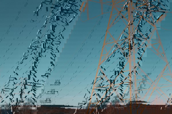 Electrical pylons outdoors at dusk